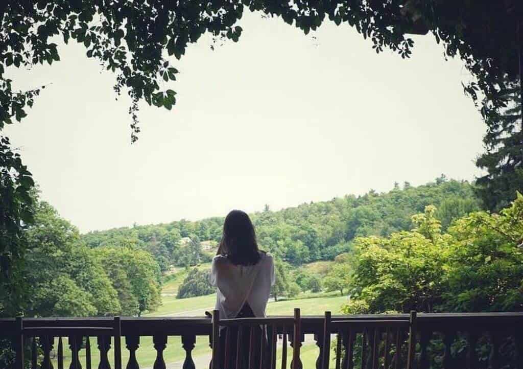 Woman Overlooking the Mohonk Grounds