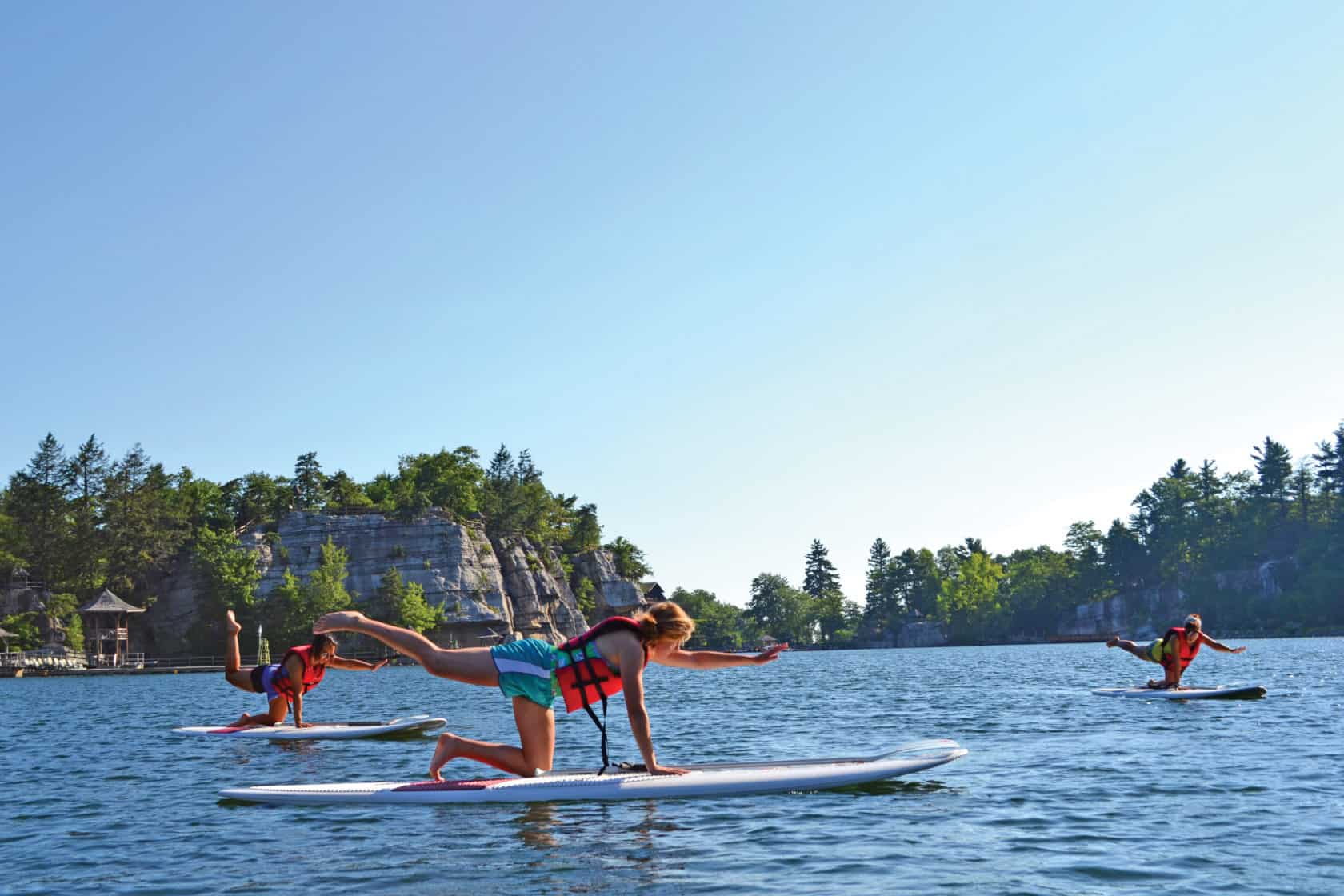 Women doing yoga on paddleboards