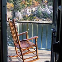 Empty rocking cChair on a balcony porch overlooking a lake
