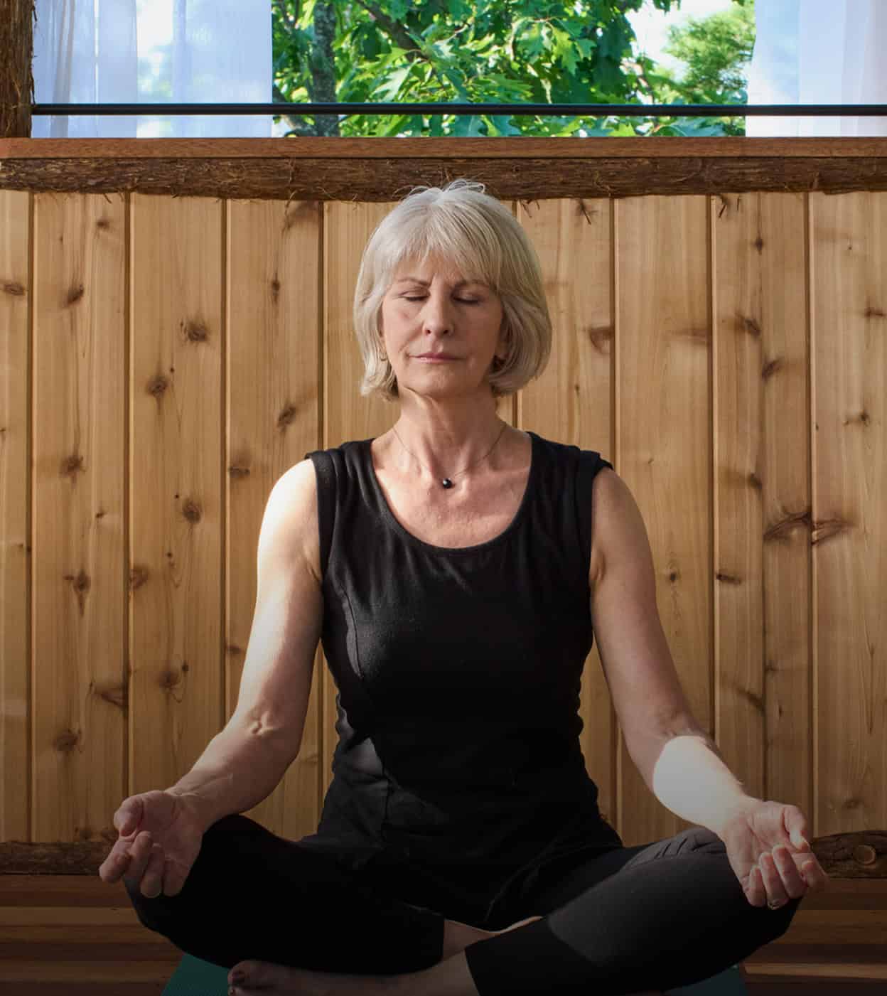 Older Woman Practicing Meditation in Our Hudson Valley Resort's Spa