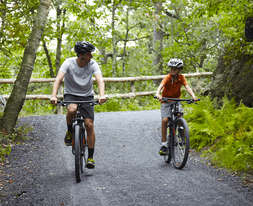 Man Mountain Biking Our Trails with His Son
