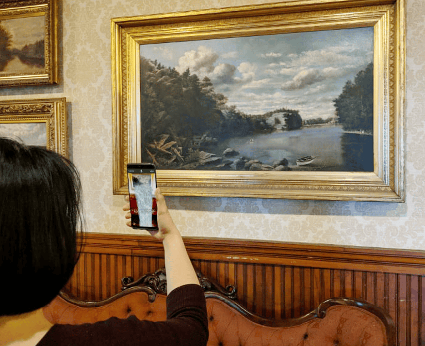 Person Exploring the History of a Painting at Mohonk