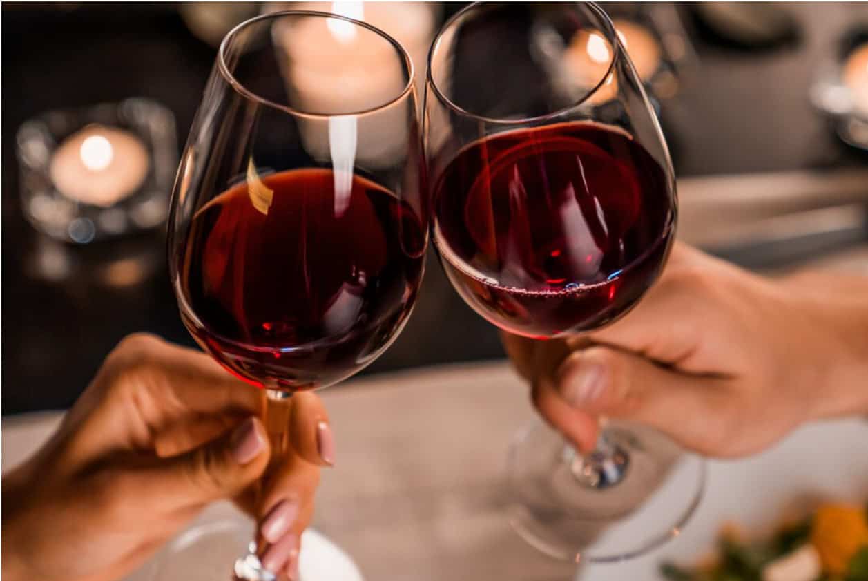 People Clinking Glasses of Red Wine