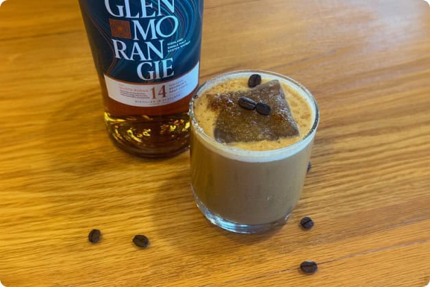 A Bottle of Scotch and a Craft Cocktail with Coffee Beans at Our New York Resort