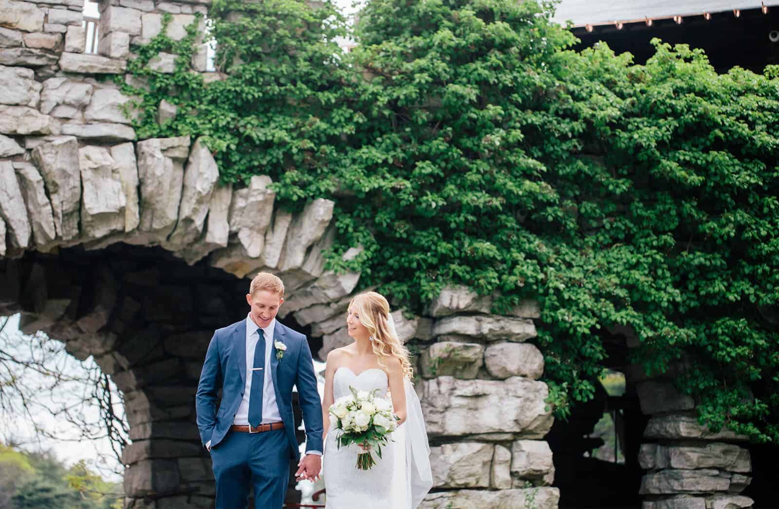 Wedding Photo of Kelly and Nick Walking Around our New York, Castle Resort