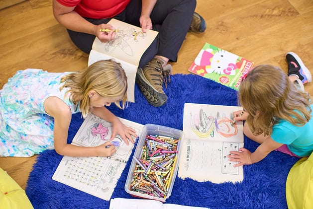Kids Drawing on the Floor with a Counselor at Mohonk's Kid's Club