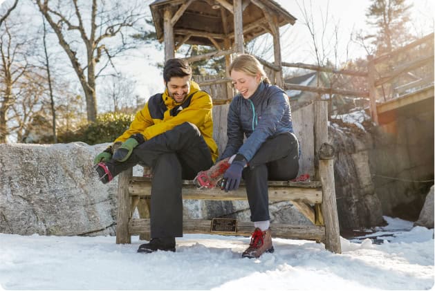 Couple Putting on Snowshoes Before Their Winter Hike in the Hudson Valley